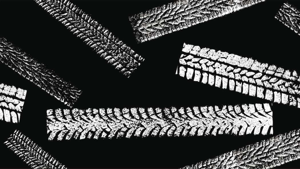 Zu früh auf Sommerpneus gewechselt – und jetzt? Zeichnung von verschiedenen Reifen-Spuren in weiss auf schwarzem Hintergrund