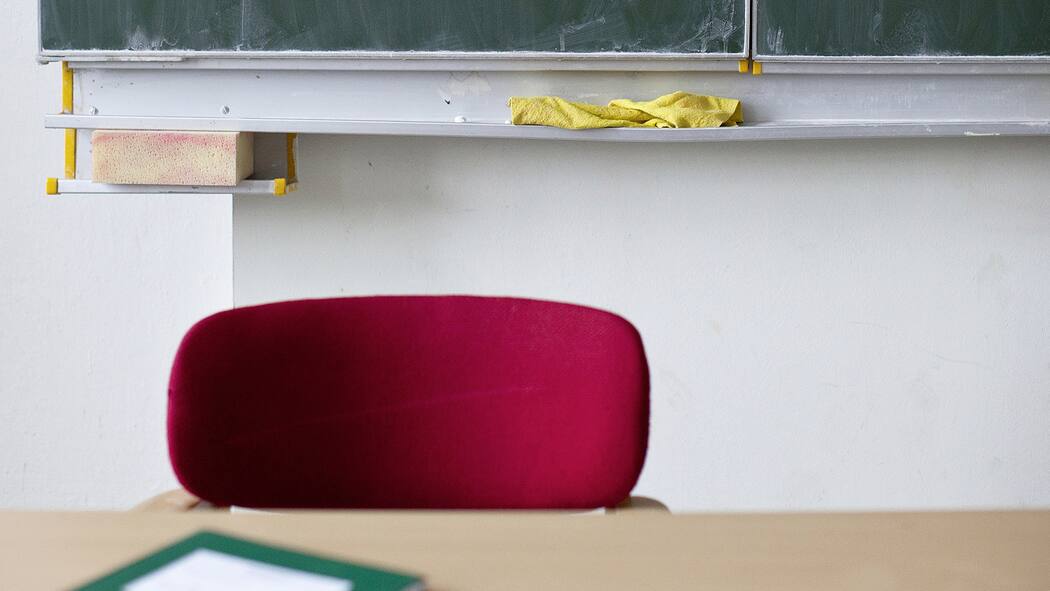 Silvia Steiners kuriose Taskforce Schulzimmer mit Stuhl, Wandtafel und Notizbuch