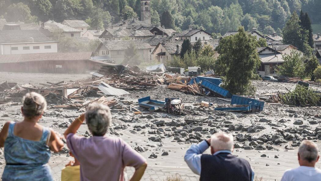 Was der Schweiz am meisten Sorgen macht – und was man jetzt tun kann Einwohnerinnen und Einwohner von Bondo GR schauen 2017 auf ihr durch einen Murgang zerstörtes Dorf.
