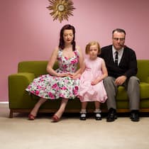 Kind da, Liebe weg Familie mit Kind im 50er-Jahre Stil auf einem Sofa. Eltern zu sein ist wunderbar. Doch die Paarbeziehung leidet oft darunter. Tipps, wie es nicht zur Trennung kommt.