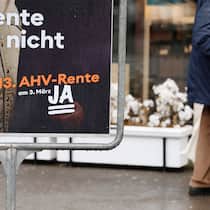 Ist das Geld dafür schon da? Symbolbild: Passant geht an Abstimmungsplakat für eine 13. AHV-Rente vorbei