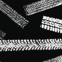 Zu früh auf Sommerpneus gewechselt – und jetzt? Zeichnung von verschiedenen Reifen-Spuren in weiss auf schwarzem Hintergrund