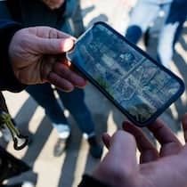 Bleiben Sie skeptisch! Eine Person schaut sich Aufnahmen eines Smartphones an, auf dem militärische Panzer zu sehen sind.