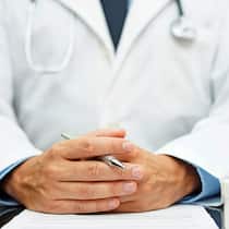 Arzt ohne Bewilligung: Patient ist selber schuld Arzt mit verschränkten Händen
