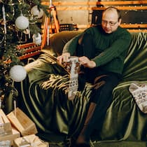 Wohin mit den No-Go-Geschenken? Mann zieht handgestrickte Socken an - Der handgestrickte Kratzpulli, das Duftset, das nach WC-Deo riecht, die Tasse vom falschen FC – nicht alle Geschenke kommen gut an. Mit dem Beobachter werden Sie sie wieder los