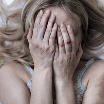 Frauenhäuser rüsten sich für die Krise Frau versteckt ihr Gesicht hinter den Händen