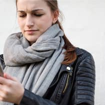 Keine Notfallnummern mehr für Geschäftskunden Frau schaut auf ihr Handy