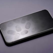 16-Jähriger reiste mit Schrotflinte und Skizzen an Many Fingerprints on Phone Screen Against White Background High Angle View.
2218450815