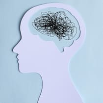 Stiftung zahlt Therapie für Traumaopfer Paper cut out of a human head with a chaotic line drawing for a brain. Burn out or mental overload Concept