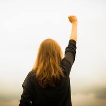 Der Resilienz-Selbsttest Frau reckt kämpferisch die Faust in die Höhe
