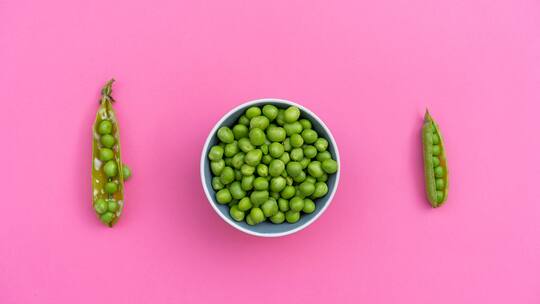 Green peas on top of colorful background. Flat lay, layout, minimal