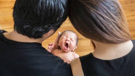 An 8-day old Japanese newborn baby boy and parents