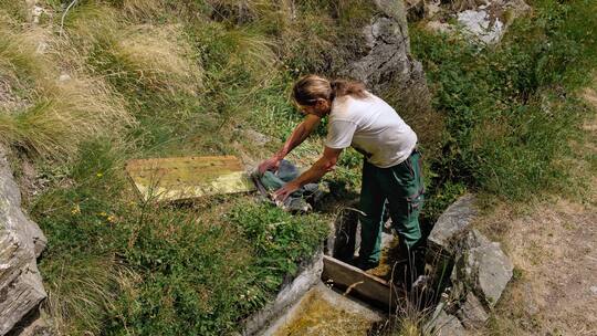 Daniel Wismer steckt einen Schieber um und leitet Wasser zu den Spritzen auf seinem Land.