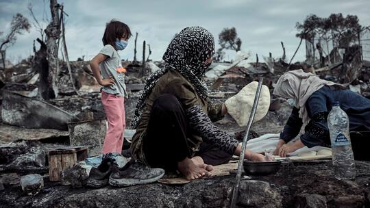 Afghanische Frauen backen Brot in den Ruinen des Flüchtlingslagers in Moria.