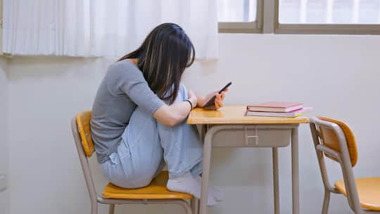 Asian depressed female student is looking at her mobile phone, and she feels upset
1646516444