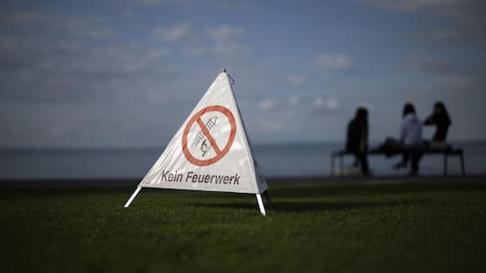 Ein Verbotsschild, das auf einer Wiese aufgestellt ist, zeigt an, dass hier kein Feuerwerk erlaubt ist - Wer Tickets für ein Grossfeuerwerk gekauft hat, fragt sich, welche Rechte man bei einer Absage hat. Der Beobachter klärt auf.