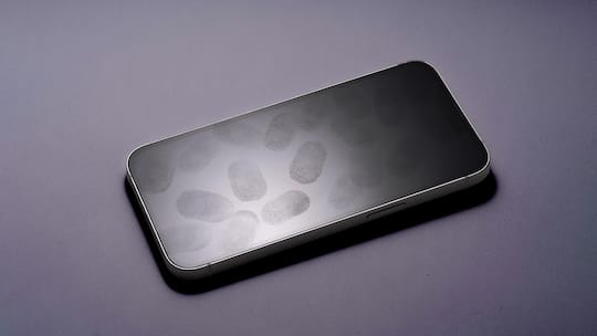 Many Fingerprints on Phone Screen Against White Background High Angle View.
2218450815