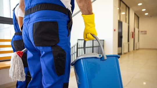 Unrecognizable janitors carrying cleaning equipment in hands, close up
2175709890