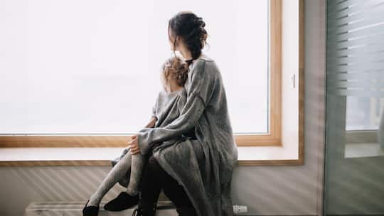 Portrait of young woman and girl looking out of window.
Original File Name: 901551996