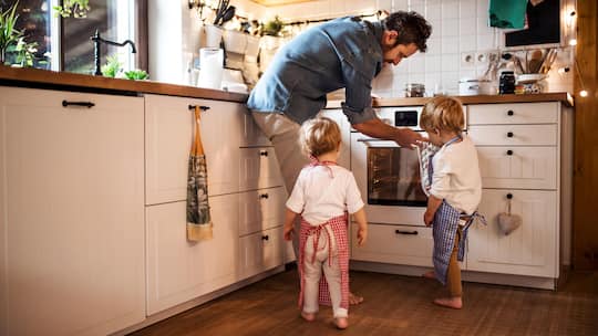 A man with son and daughter at home, making cakes.
1168239595