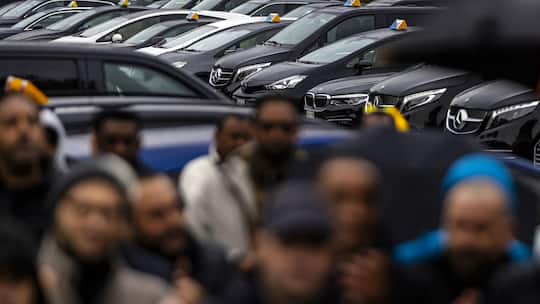 Uber and taxi drivers gather to strike at Albisguetli, on Monday, October 20, 2025, in Zurich, Switzerland. Drivers of the US ride-hailing service Uber and other drivers strike as they gather for a protest to draw attention to Uber's current working …