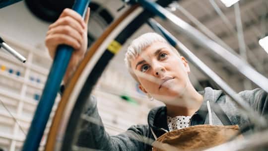 Bike shop owner repairing a vintage bicycle