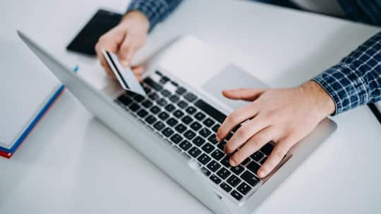 Typing on the laptop and using credit card
873050824