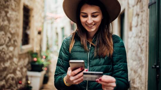 Jugendliche mit Smartphone und Kreditkarte