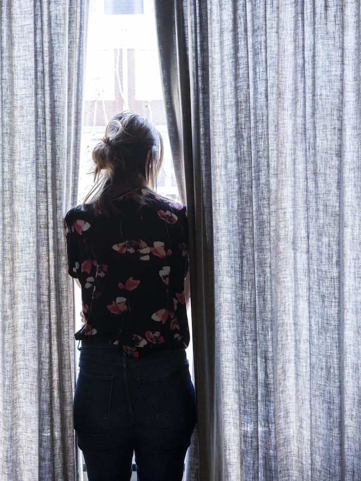 Eine Frau schaut aus dem Fenster.