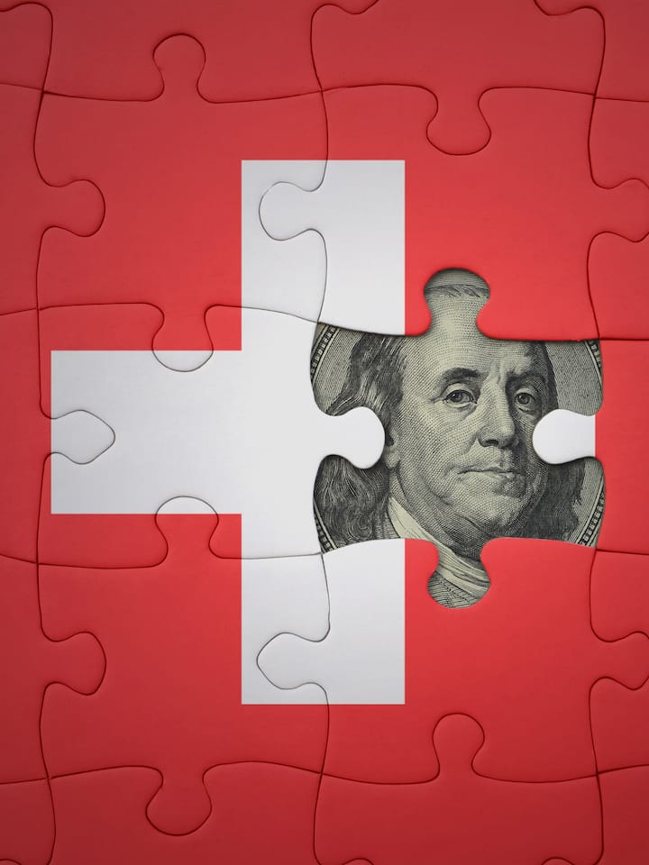 puzzle with the colourful national flag of switzerland and usa dollar banknote. finance concept