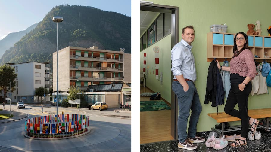 Kreisel in Visp mit vielen Landesflaggen – rechts: Gemeinderat Michael Lochmater-Bringhen und Kita-Chefin Elisabeth Jordan